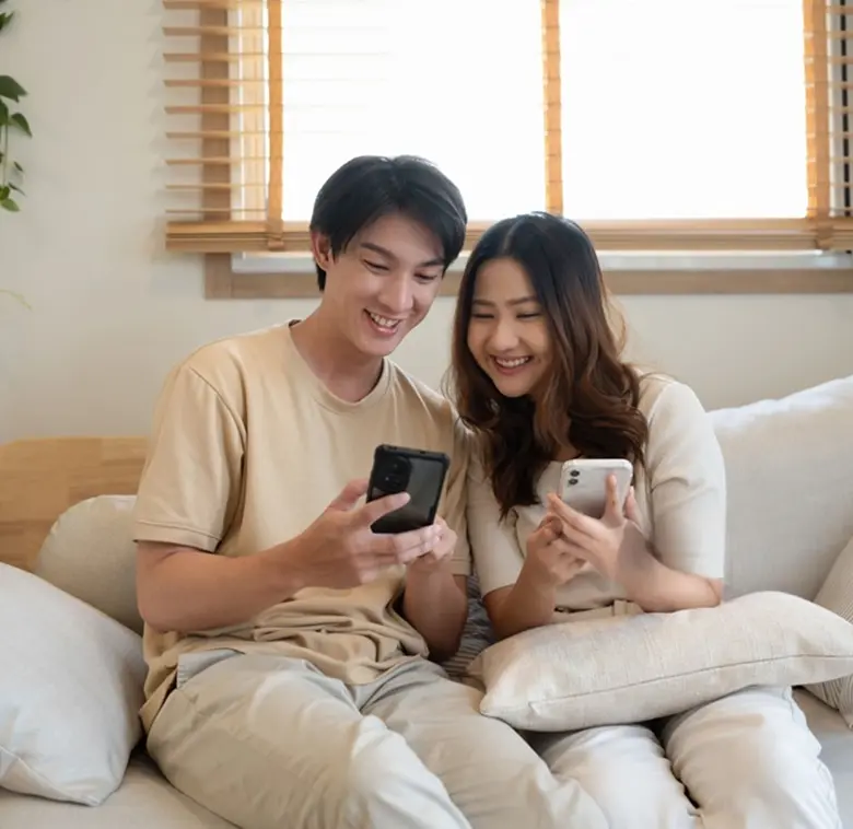 Couple browsing real estate on their phones
